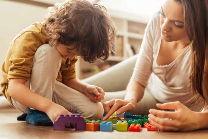 a woman playing with her kid