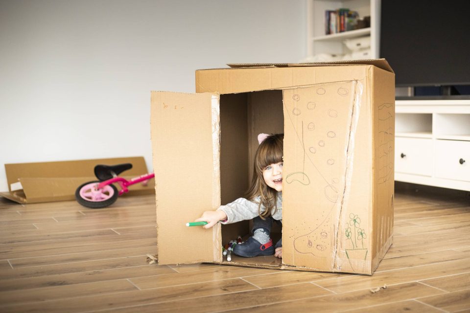 little girl in a moving box