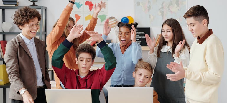 children having fun in a classroom with their teacher.