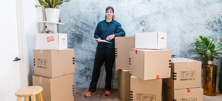 one of the Bethesda movers surrounded by moving boxes