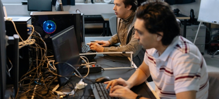 Two men learning how to choose a data migration company.