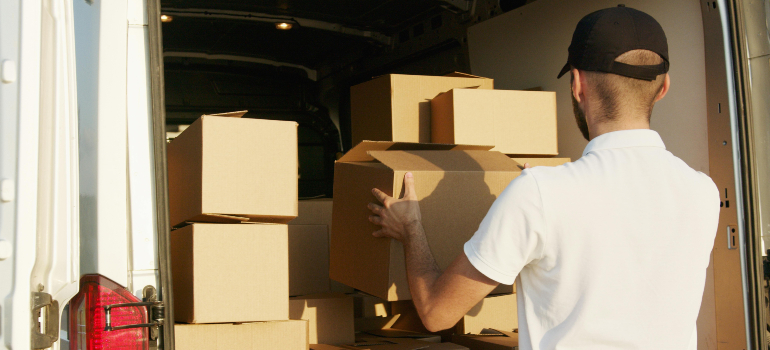 a mover loading a truck with boxes 