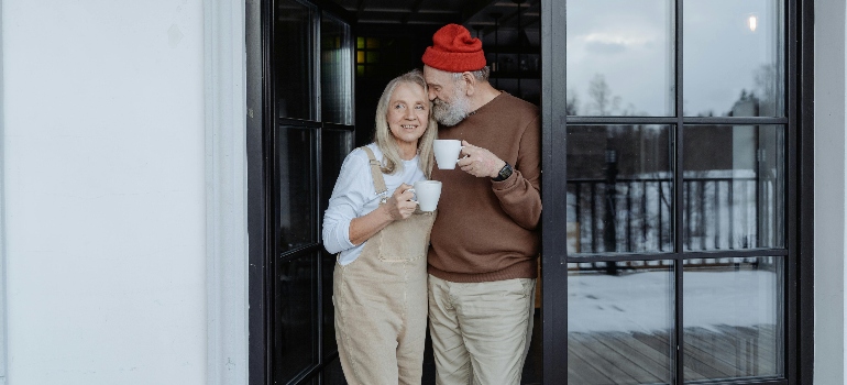 a couple with cups talking in process of deciding to downsize 