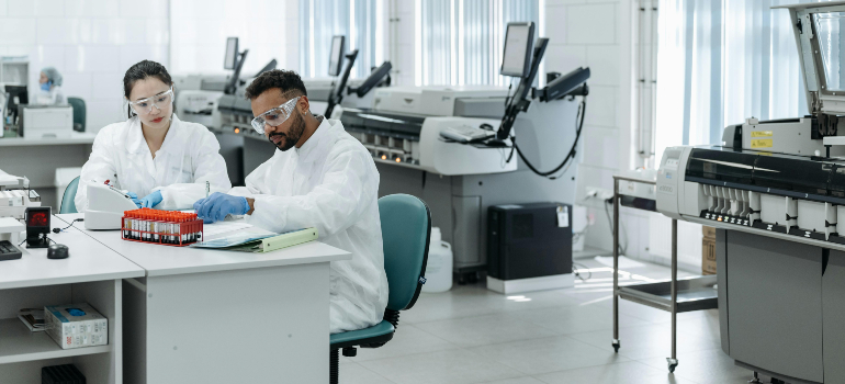 two people doing an experiment in a lab where laboratory's design and layout can improve efficiency and accuracy