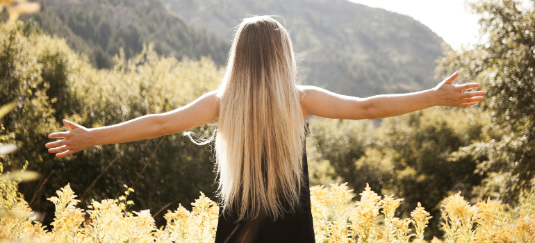 woman with spread arms in the nature