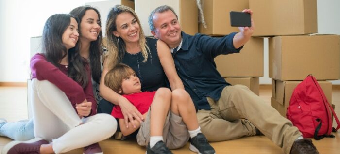 a happy family taking a photo talking about how Interstate Relocation simplifies your cross-country moving experience