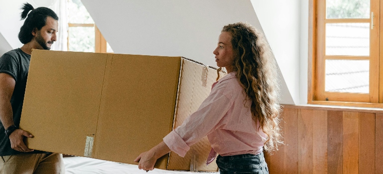 a couple holding a box 