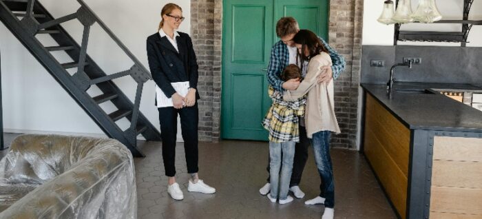 a real estate agent showing a family their new home and talking about weather to renovate or relocate