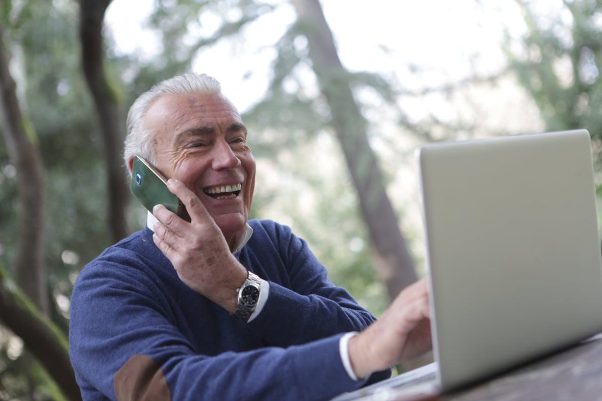 an elderly man talking over the phone