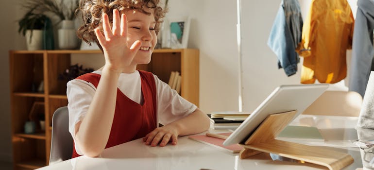 a kid waving to the camera