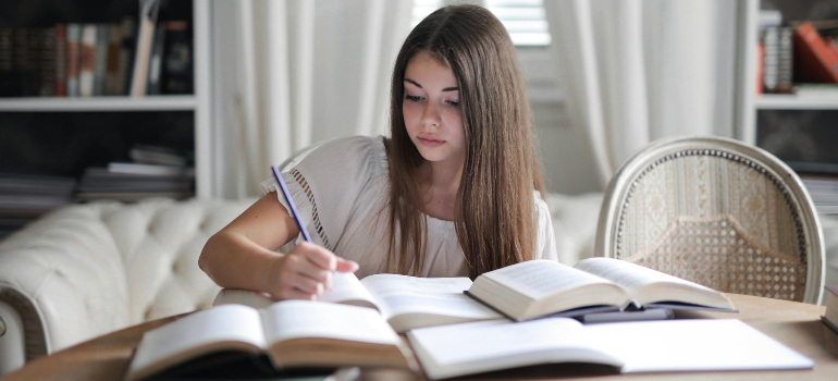 girl studying at a desk after the process of international moving with children