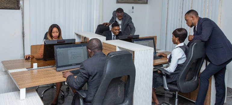 People in the office working on a problem. 