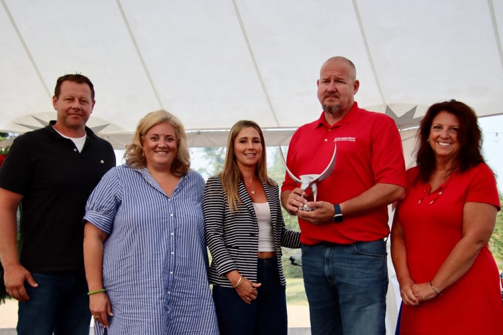 Interstate Van Lines team posing with their award 