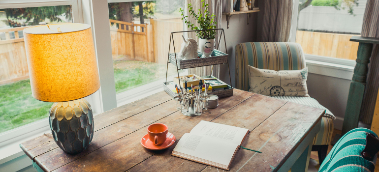 lamp and a book on a wooden table