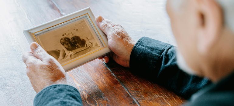 elderly man looking at a photograph