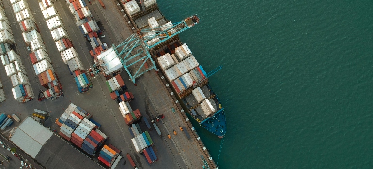 an aerial view of a ship in the port representing Shipping Through Smaller Ports