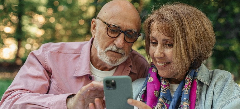 Happy Couple Using Cellphone