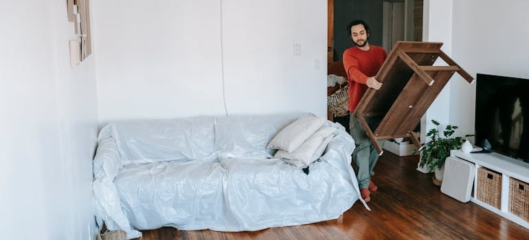 a man carrying a table 