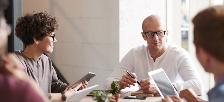 people in a meeting managing supply chain disruptions during hotel renovations or moves