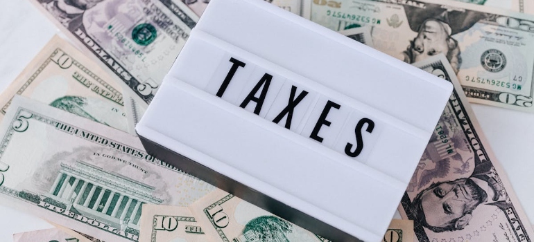Taxes Quote Board on top of Cash Bills