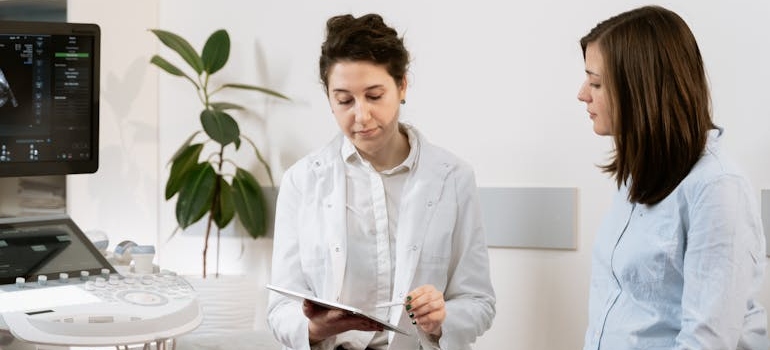 a doctor talking to a pregnant patient