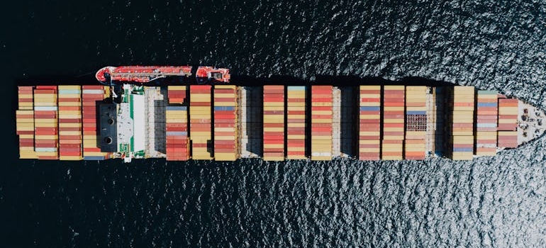 Directly Above a Fully Loaded Cargo Ship on a Sea 
