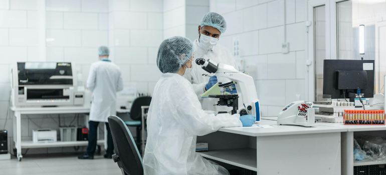 people working in a lab and discussing moving sensitive medical equipment