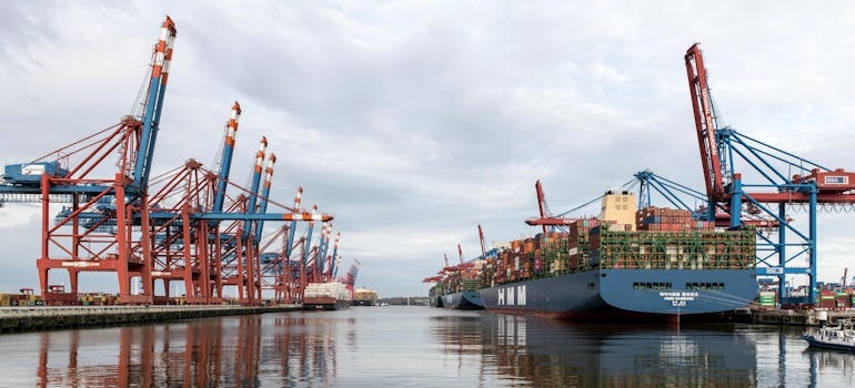container ships in a dock handled by professionals who have project cargo certifications