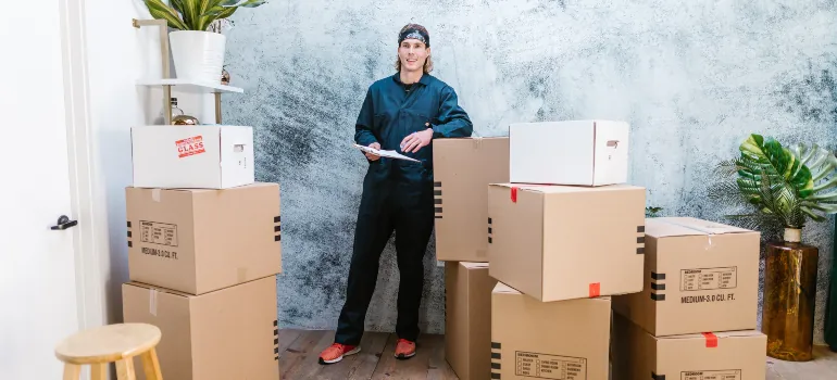 one of the Bethesda movers surrounded by moving boxes