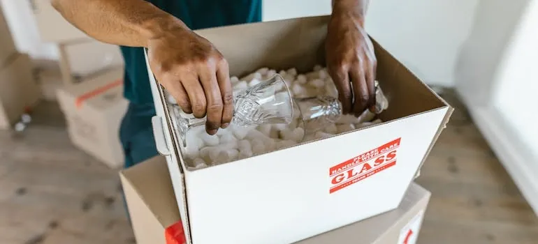 one of the movers in College Park packing glasses 